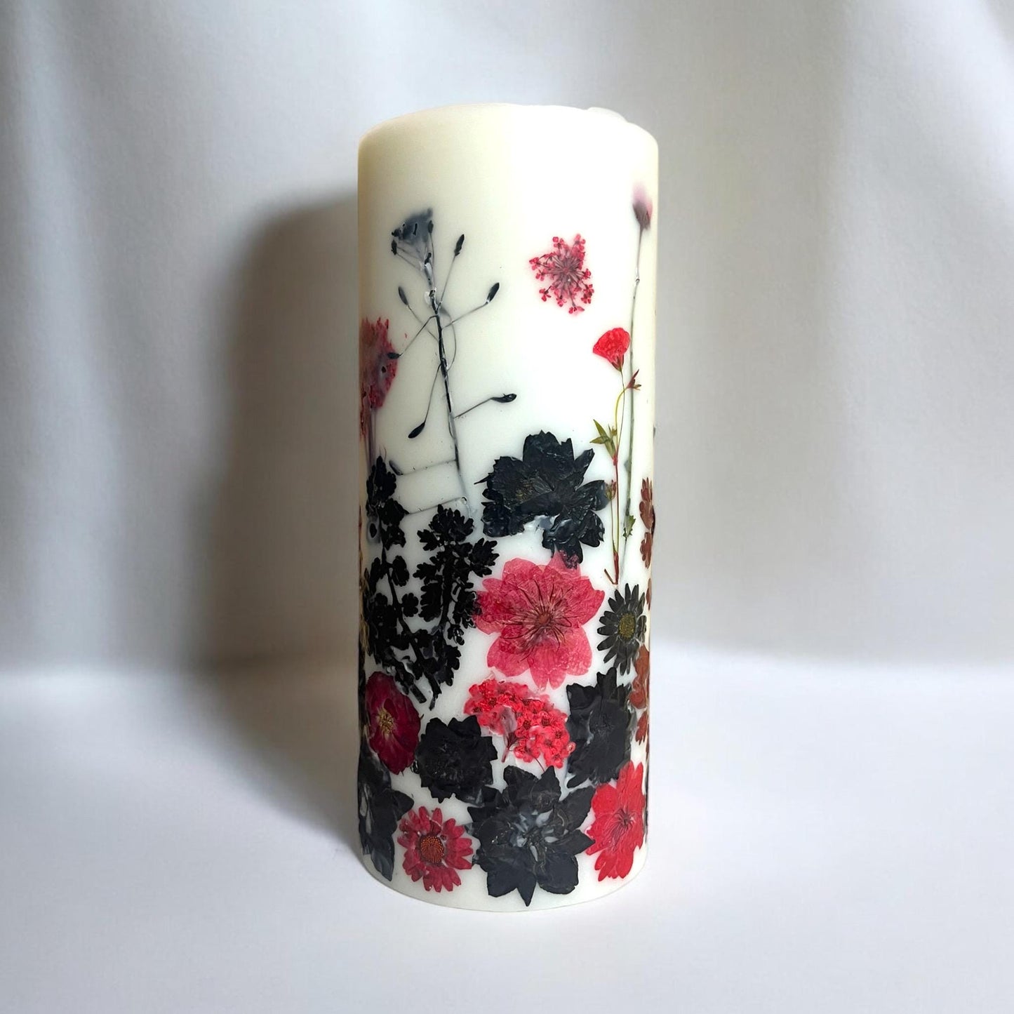 Pressed Flower Pillar Candle: Red & Black Botanical Design.