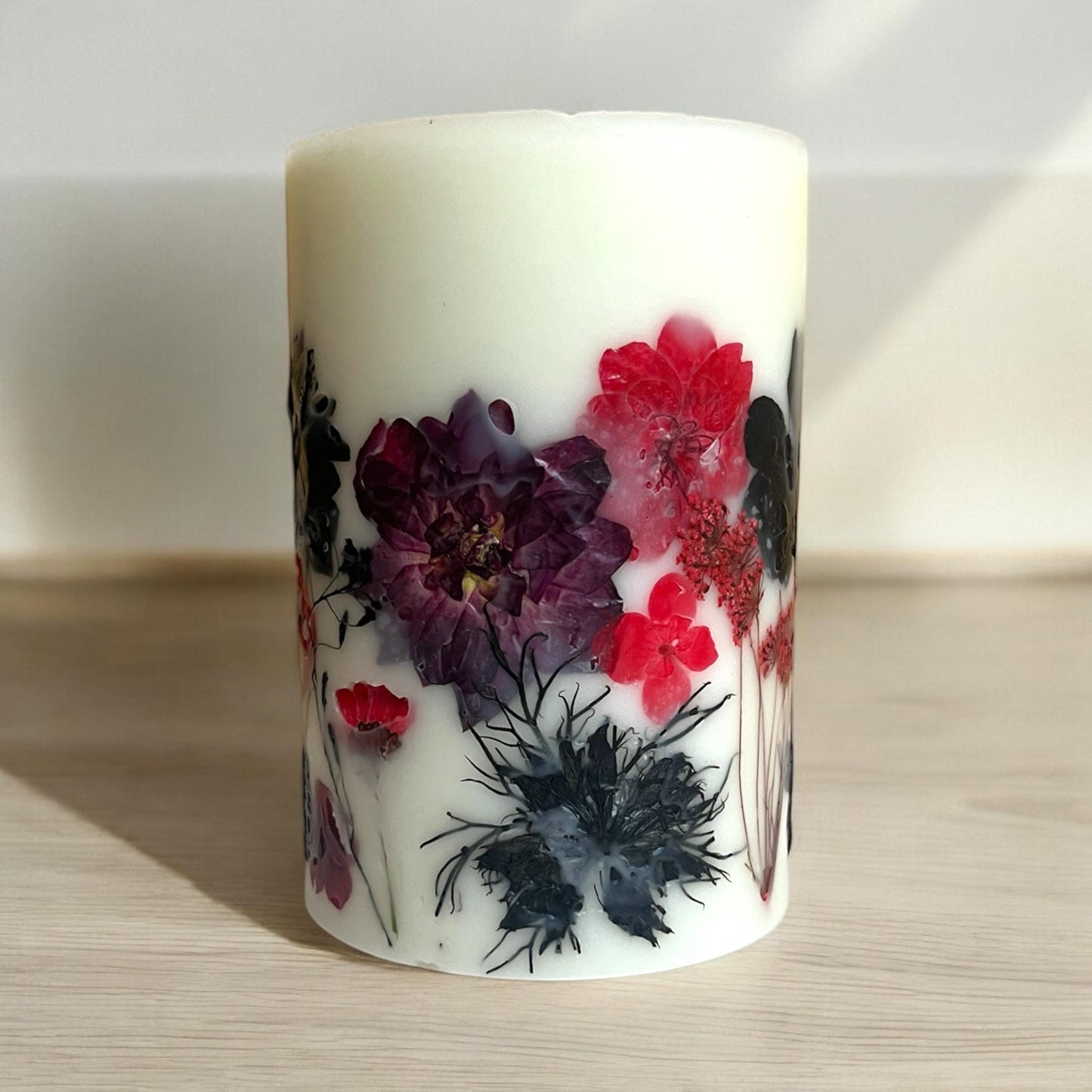 Pressed Flower Pillar Candle: Red & Black Botanical Design.
