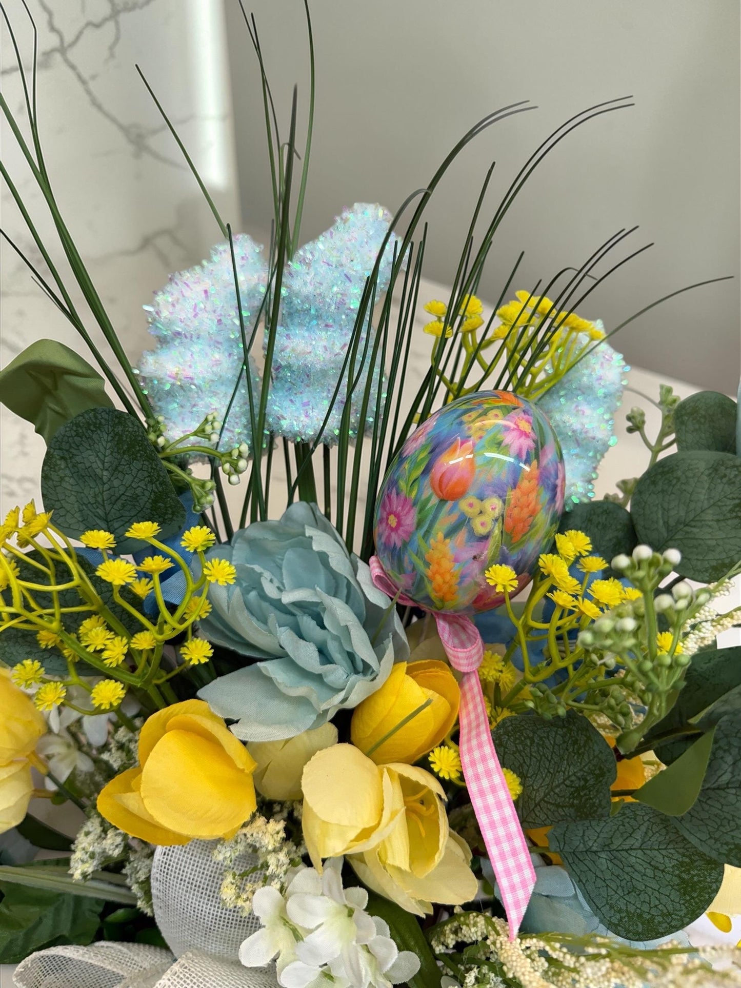 Easter Spring Faux Floral Arrangement with Bow Centerpiece Decoration featuring Yellow, Light Blue and Greens.