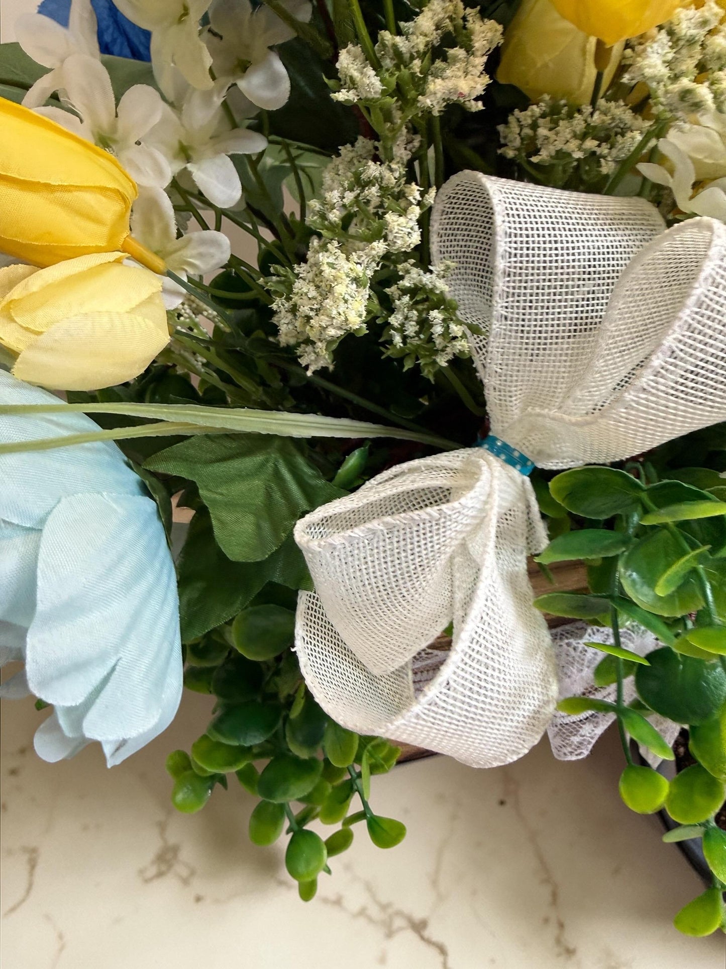 Easter Spring Faux Floral Arrangement with Bow Centerpiece Decoration featuring Yellow, Light Blue and Greens.
